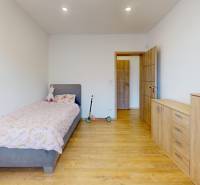 Children's room in a family house with a wooden decor floor and furniture.