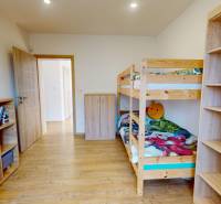 Children's room in a family house with a bunk bed and wooden furniture.