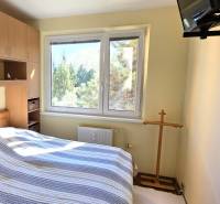 Bedroom with a double bed and built-in wardrobes in a 3-room apartment.