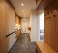 Entrance hall of a 3-room apartment with storage cabinets and hanging hooks.
