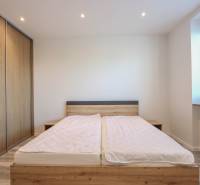 Bedroom in a 3-room apartment with a bed and a built-in wardrobe with a wooden decor.