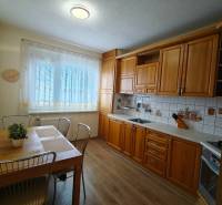 A kitchen in a 3-room apartment with a kitchen unit and a dining table.