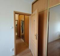 Built-in wardrobes with doors and flooring with a wood decor, 3-room apartment.