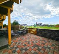Terrace at a 2-room apartment in Veľká Lomnica with a view of the children's playground and greenery.
