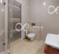 A bathroom in a 2-room apartment with a toilet, shower, and modern sanitary facilities.