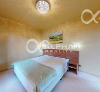 A bright bedroom in a 2-room apartment with a painting on the wall and a comfortable bed.