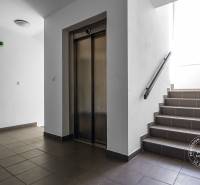 Hallway with an elevator and staircase in the building on Vincenta Šikulu Street in Stupava.
