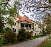 A historic building surrounded by trees on Vincent Šikula Street in Stupava.