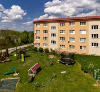 Apartment building on Vincenta Šikulu Street in Stupava, with a playground in the foreground.