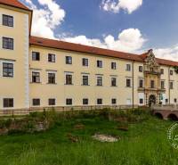A historical building in Stupava on Vincent Šikula Street with a landscaped park.
