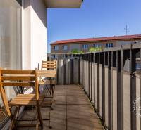 Balcony with wooden chairs in a 2-room apartment in Stupava on Vincenta Šikulu.