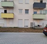 Apartment building on Nyárfa in Bratislava - Jarovce with a parking lot in the foreground.