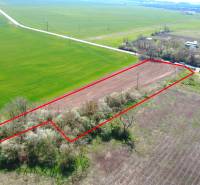 A plot of land in the area of Záhrady Ondrejovce, surrounded by fields and houses, bordered by a red line.