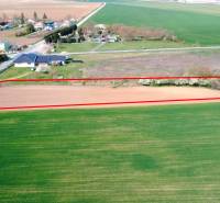 A plot in the gardens of Ondrejovce, bordered by a red line, surrounded by open countryside.
