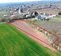Aerial view of agricultural land in Ondrejovce surrounded by gardens and the village.