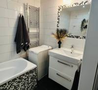 Elegant bathroom with tiles, sink, and bathtub, part of a 3-room apartment.