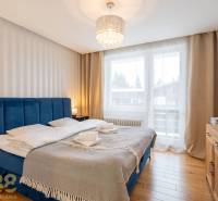 Bedroom in a holiday apartment with a comfortable bed and a wooden decor floor.