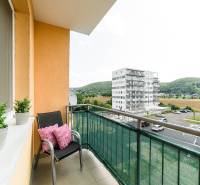 The balcony of a 2-room apartment on Armádna Street in Trenčín with a view of the surrounding buildings.