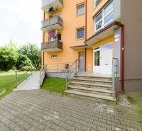 Apartment building on Armádna Street in Trenčín with access stairs and greenery.