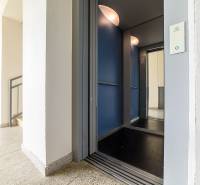 On Armádna Street in Trenčín, there is an elevator and a staircase of an apartment building.