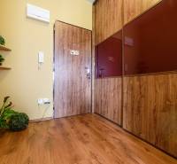 Interior of a 2-room apartment with a wooden decor floor and wooden details.
