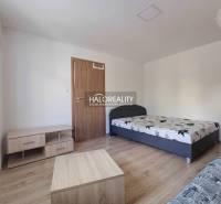 1-bedroom apartment with a bed and furniture on a floor with a wood decor.