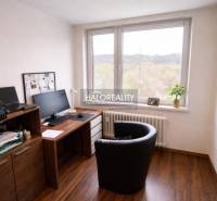 A study in a 4-room apartment with a wooden decor floor and a large window.