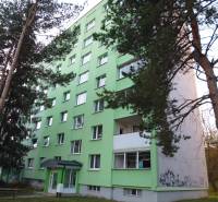 An apartment building in Prešov with surrounding trees and 7 floors.