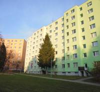 A housing estate with apartment buildings in Prešov, surrounded by greenery and a park.