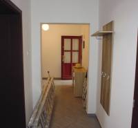 A hallway in a 3-room apartment with a ladder and a cabinet, floor with wood decor.