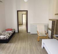 Living room in a 3-room apartment with a wooden decor floor and light furniture.