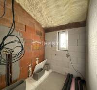 The interior of an under-construction bathroom in a family house with preparations for installations.
