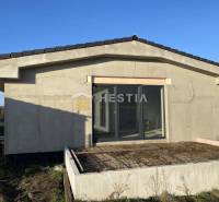 A family house in the town of Sekule with an unfinished terrace and large glass doors.