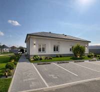 A family house in Zemianska Olča with a garden, parking, and a paved walkway.