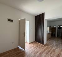 A family house with white walls and a wooden decor floor, spacious entrance area.