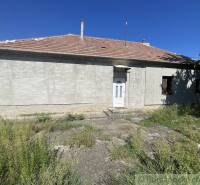 A family house in Jatov with a simple facade and surrounding greenery.