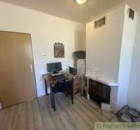 Interior of a family house with a fireplace, a desk, and a floor with a wood decor.
