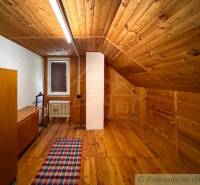 The interior of a cottage with a wooden decor floor and rustic furniture.
