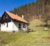 A cottage in Moštenica near the forest surrounded by greenery with a swing in the garden.