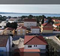 Aerial view of family houses on Mulo Street in Vrsi with a sea view.