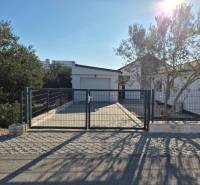 Family house in Vrsi on Mulo street with a gate, paving, and greenery.