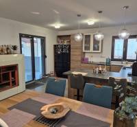A kitchen in a family house with a dining table and a floor with a wooden decor.