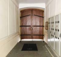 A corridor with large wooden doors and security lockers in Bratislava on Konventná.