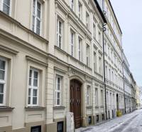 Snow-covered Konventná Street, Bratislava - Old Town, with ancient building facades.