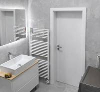 Bathroom in a 2-room apartment with a sink, mirror, and towel rack.
