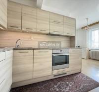 A kitchen in a family house with a wooden decor floor and a modern kitchen unit.