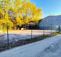 Lands - commercial in Nitra, fenced area with surroundings covered by trees.