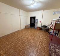 Room in a family house with shelves, boxes, and a wooden decor floor.