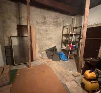 Storage space in a family house with shelves and randomly placed items.