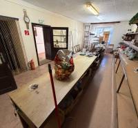 The interior of a family house with older furniture and shelves for storing items.